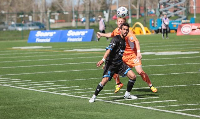 Hat-trick goal scorer Shaun Saiko wins a ball against a RailHawks defender